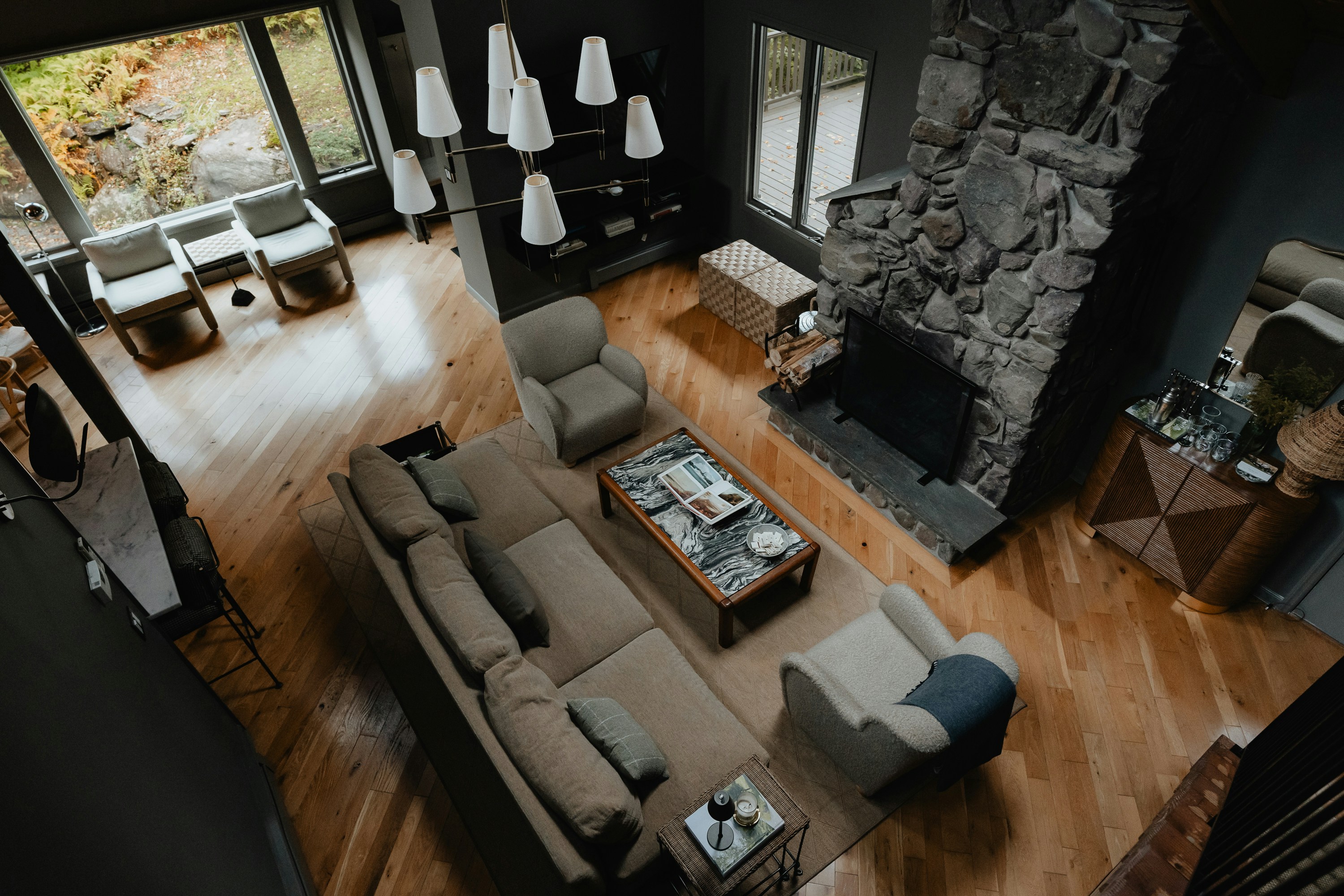 Modern living room with stone fireplace and hardwood floors